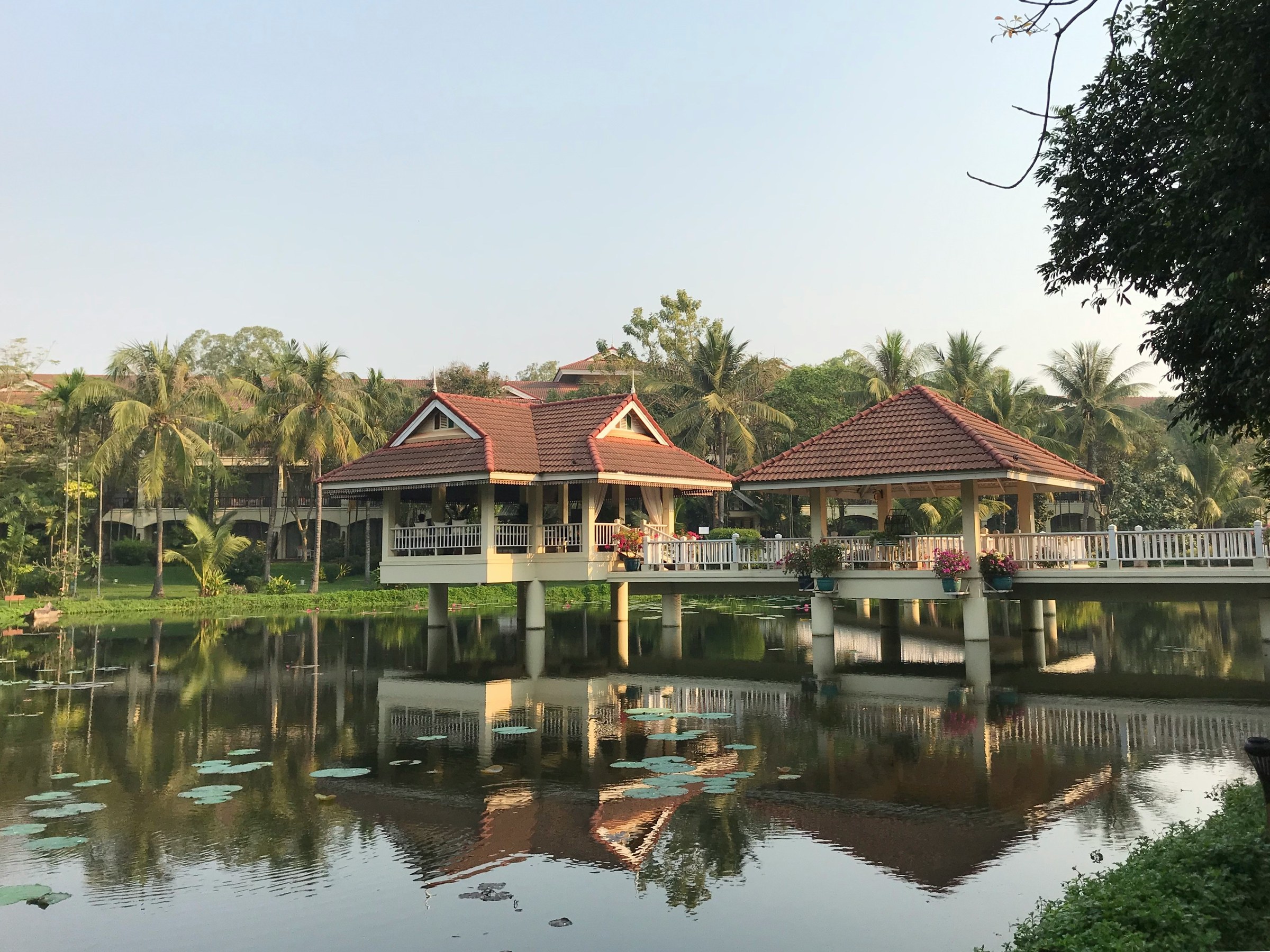 Lakeside pavilion reflected in still water Cambodia