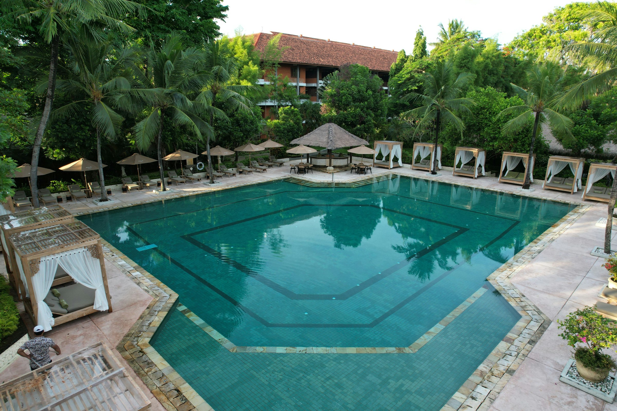 Resort pool with cabanas tropical garden
